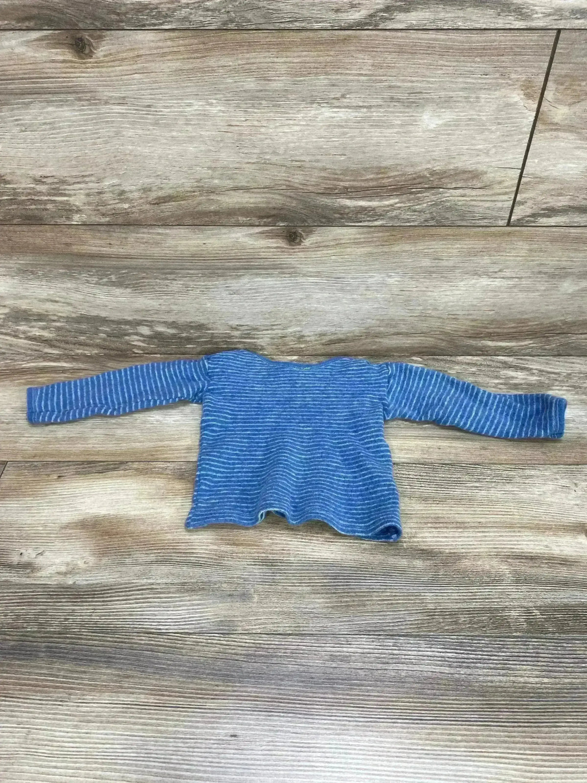 Front view of blue striped wool baby shirt by Hocosa, long sleeves and crew neck, on white background, size 9-12 months