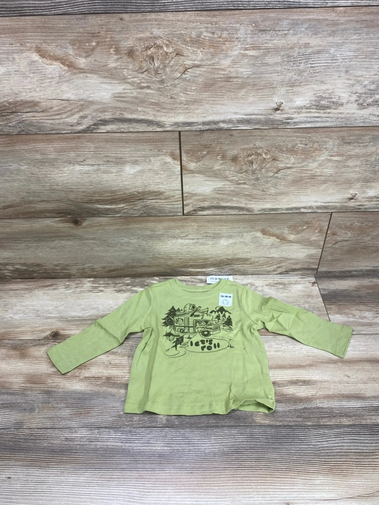 Front view of green Old Navy baby shirt with Let’s Roll printed design, size 12 to 18 months on white background