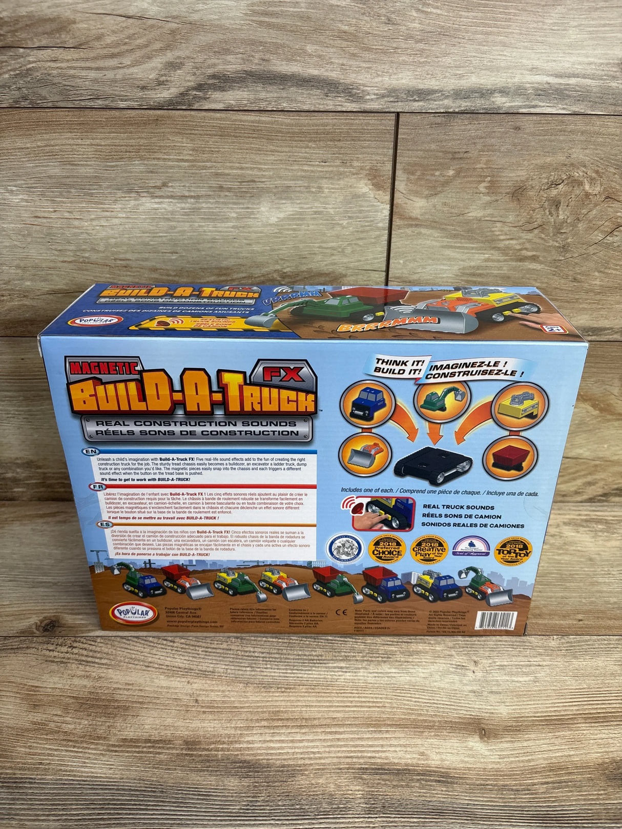 Back of Magnetic Build-A-Truck FX toy box with images of toy trucks and construction-themed graphics