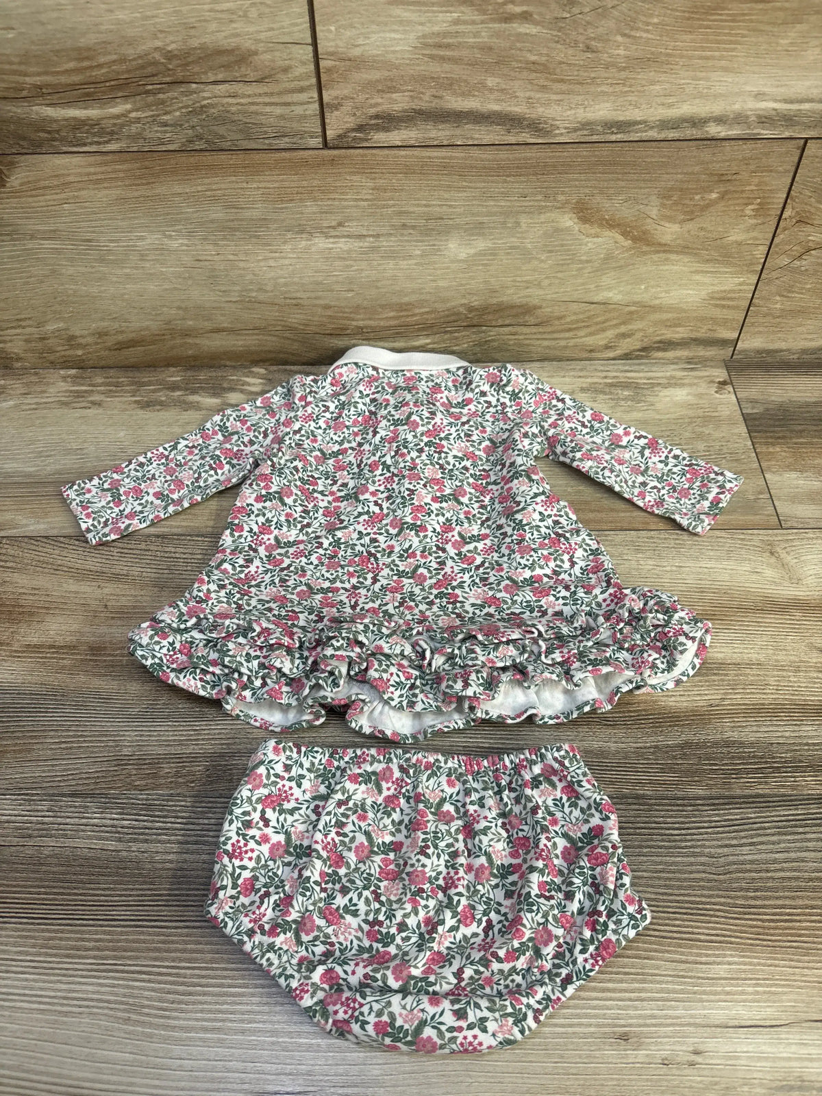 Front view of Ralph Lauren pink 2pc ruffled floral dress with three-tier hem and matching bloomer on wood-look flooring
