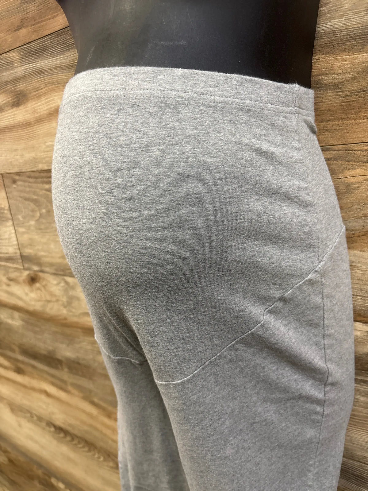 Close-up side view of Time and Tru maternity over-belly leggings in grey, showing the high waistband and stitched leg panel