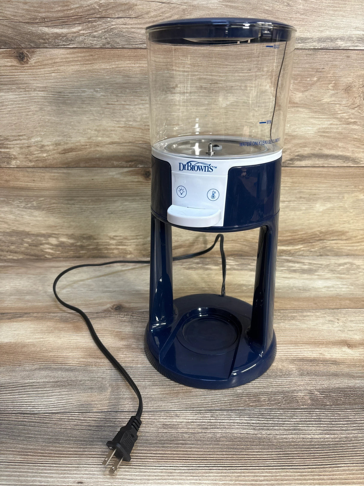 Dr. Brown's electric baby bottle sterilizer with clear water tank on wood background