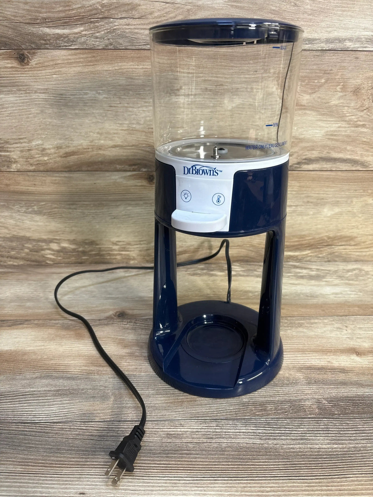 Front of Dr. Brown’s Insta-Prep Warm Water Dispenser showing clear tank, dispenser button, navy base and power cord