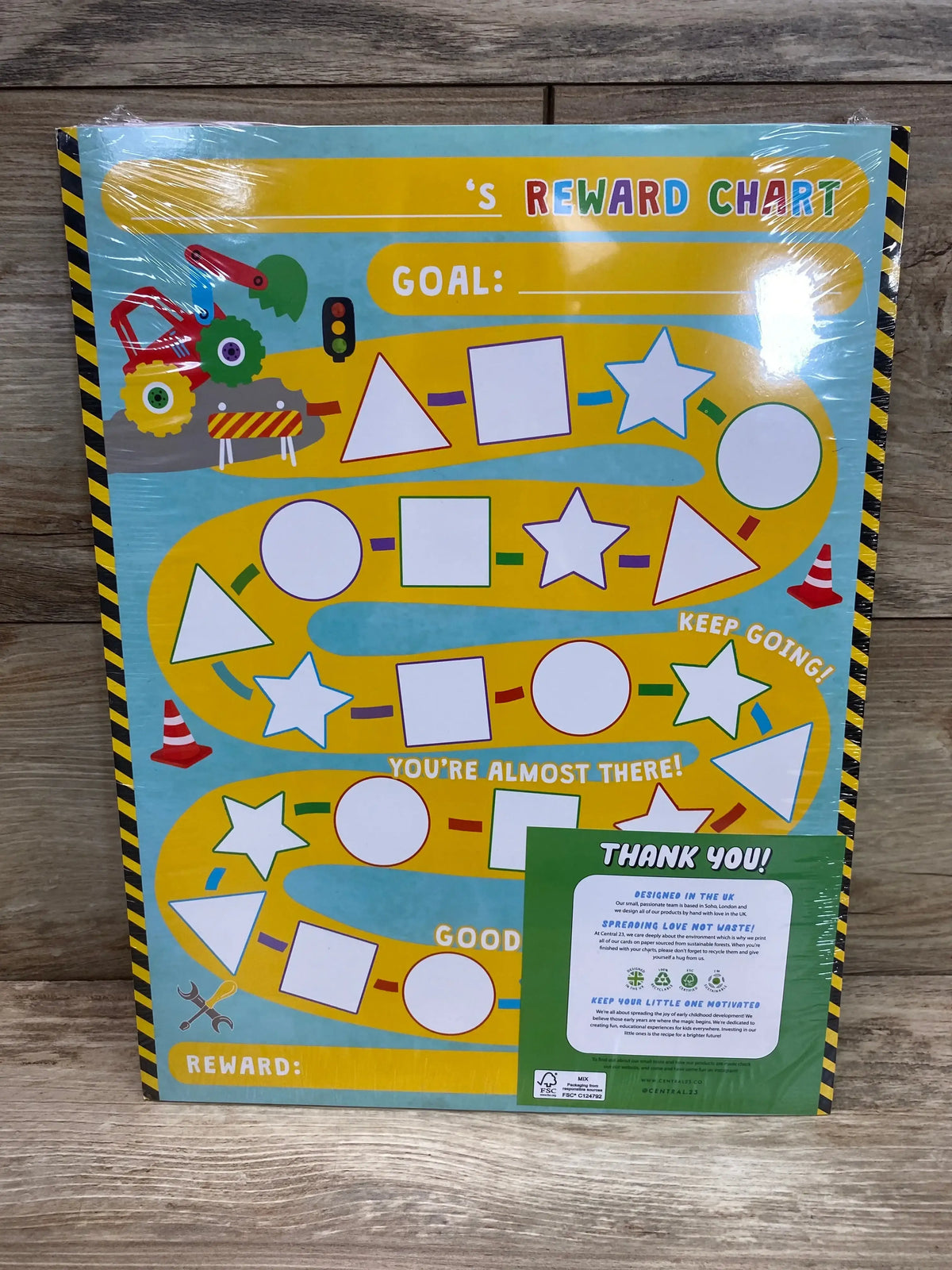Front view of children’s reward chart showcasing colorful path with blank shape spots and GOAL field on wood background
