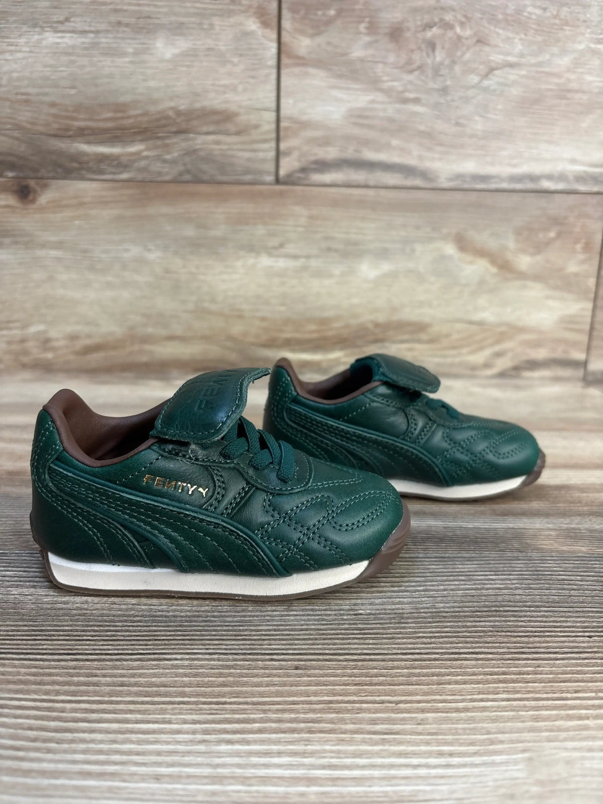 Green Fenty baby sneakers with velcro straps, toddler shoes for walking, kids footwear on wood floor