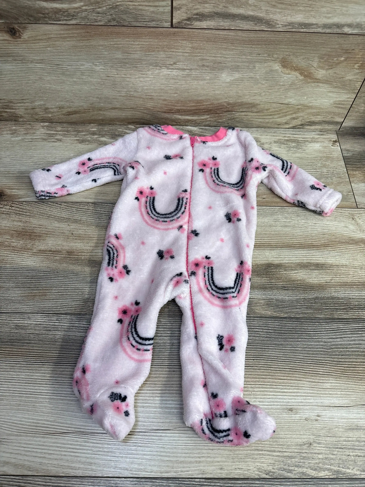Pink fleece baby sleeper with rainbow and flower print, long sleeves, and zipper closure