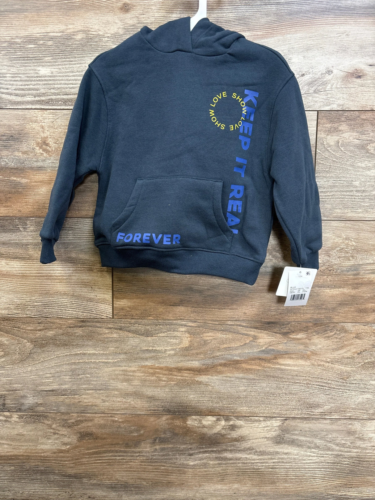 Front view navy toddler hoodie size 3T with KEEP IT REAL and SHOW LOVE prints, kangaroo pocket on wood