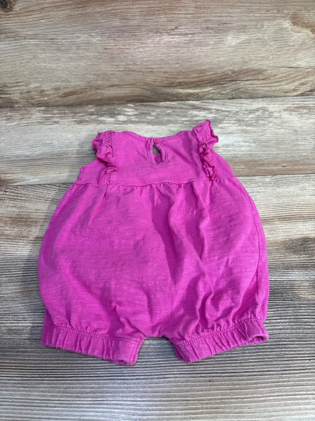 Top view of Just One You 3M pink ruffle shortie romper with ruffled sleeves, elastic leg openings and back keyhole on wood
