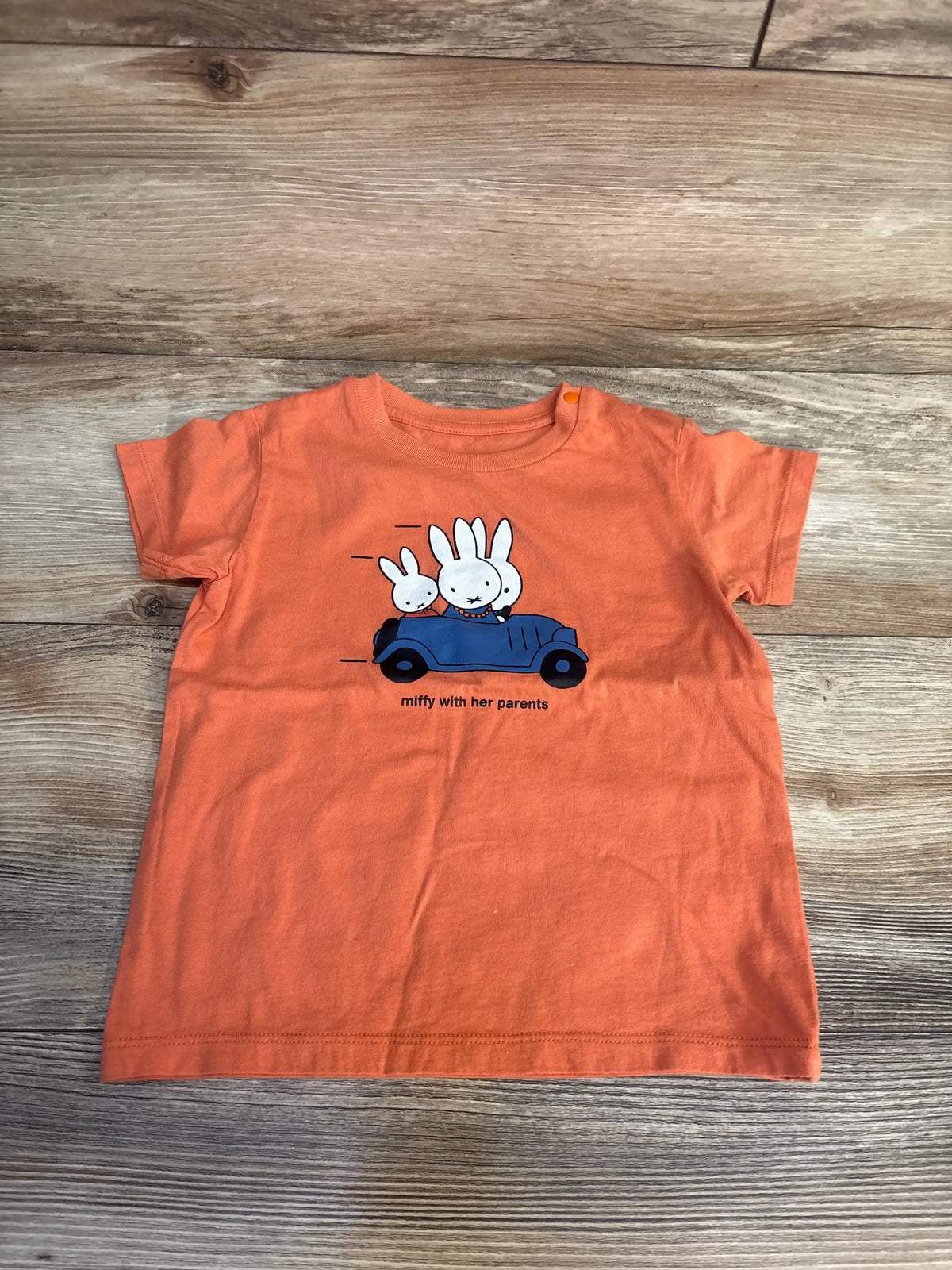 Orange kids t-shirt with Miffy and parents in blue car graphic, perfect for toddler clothing resale.