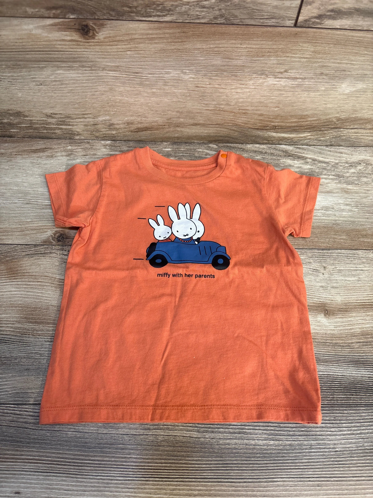 Orange kids t-shirt with Miffy and parents in blue car graphic, perfect for toddler clothing resale.