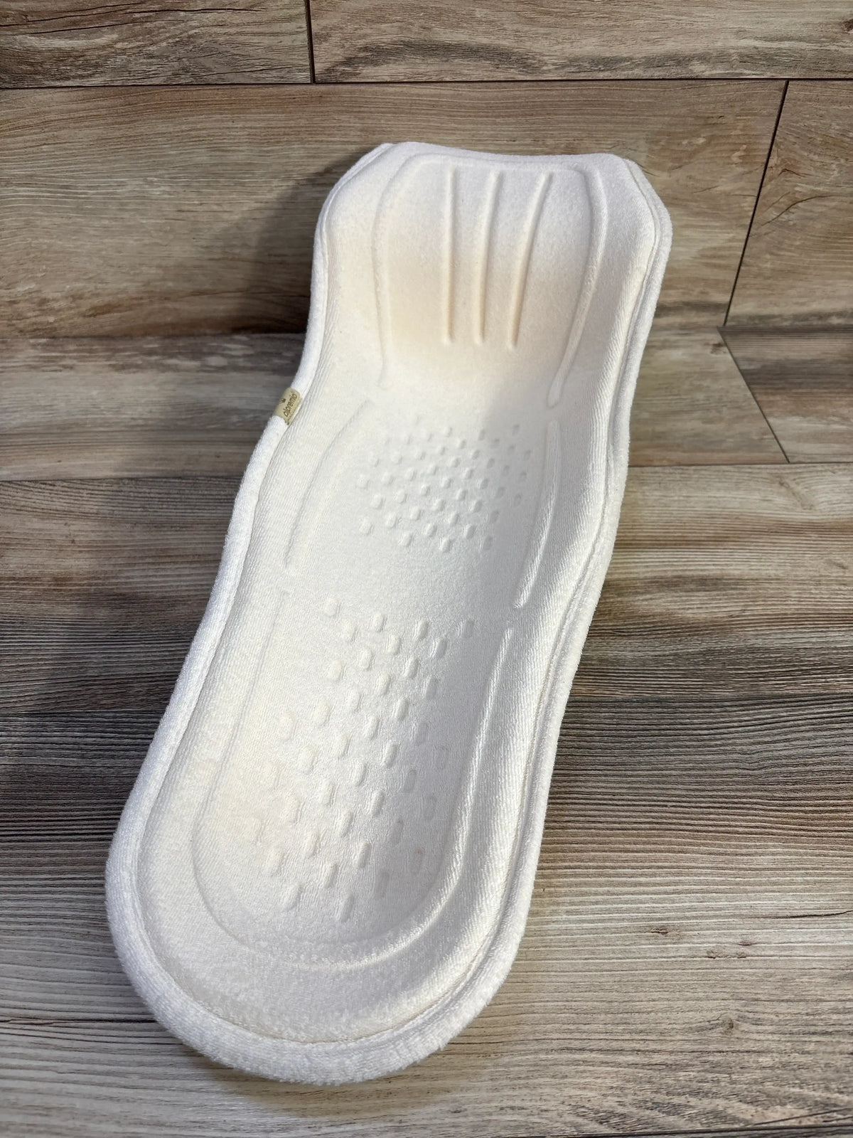 Front view of Alpremio Multifunctional feeding and care seat showcasing white breathable mesh support on wood floor