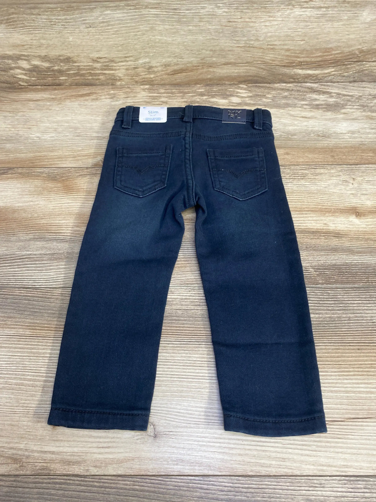 Back view of Mayoral slim fit baby pants size 12 months showcasing rear pockets and slim navy color on wood background