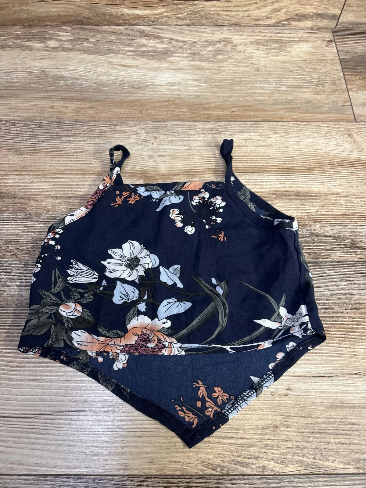 Front view of Shein cropped tank top in navy, size 2T, showcasing floral print and thin straps on a wood-look floor