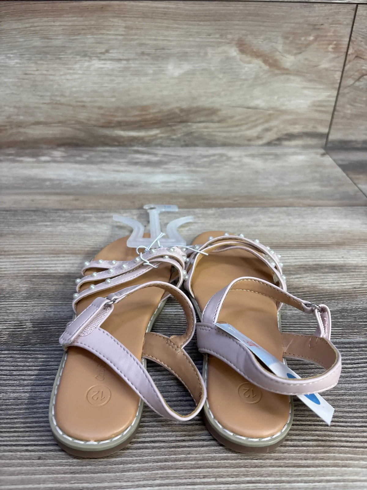 Front view of Cat & Jack toddler pearl-strap sandals, blush straps with pearl beads, size 12c visible on wood background