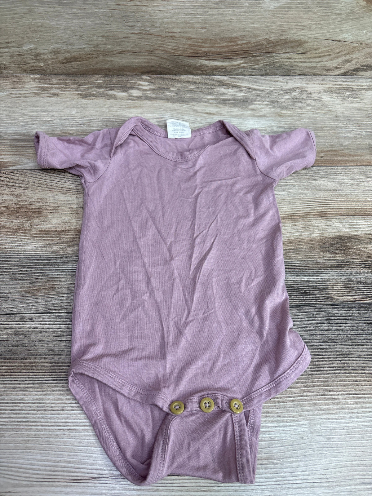 Front view of pink Kate Quinn Beechwood bodysuit, size 6 to 12 months, with short sleeves and three bottom snaps on wood grain