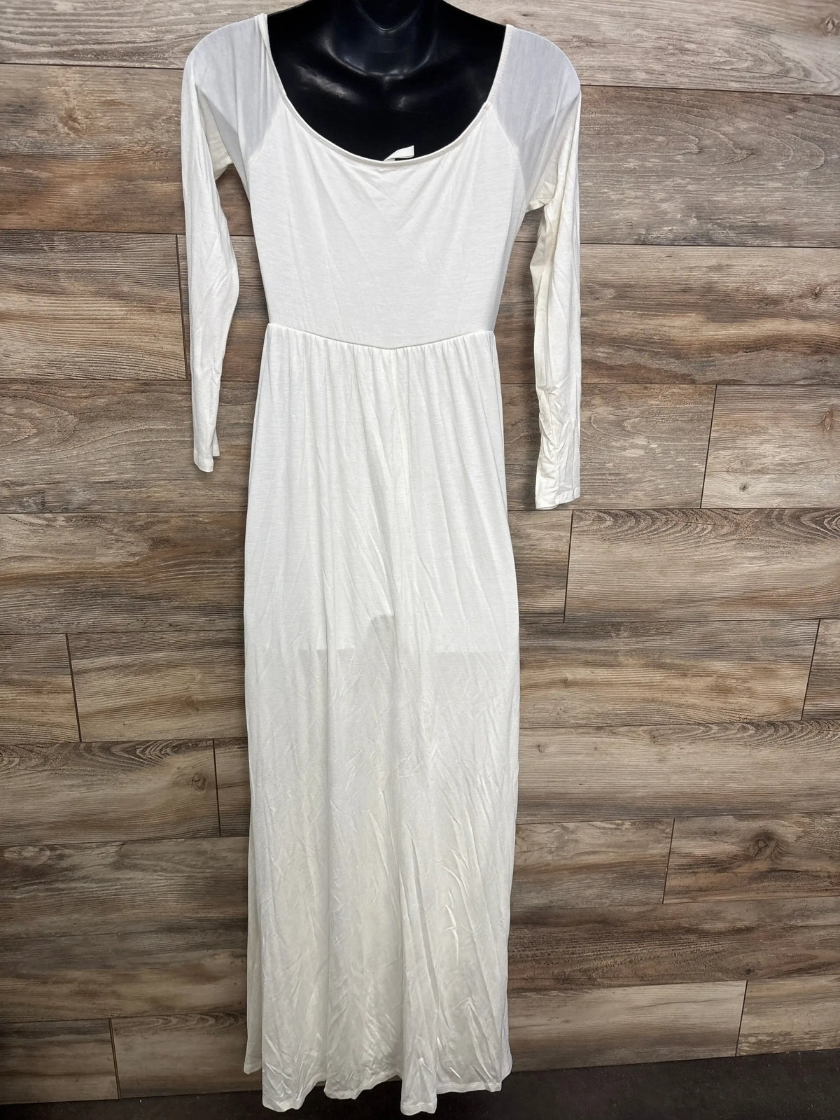 White long sleeve maternity maxi dress displayed on mannequin against wooden background.