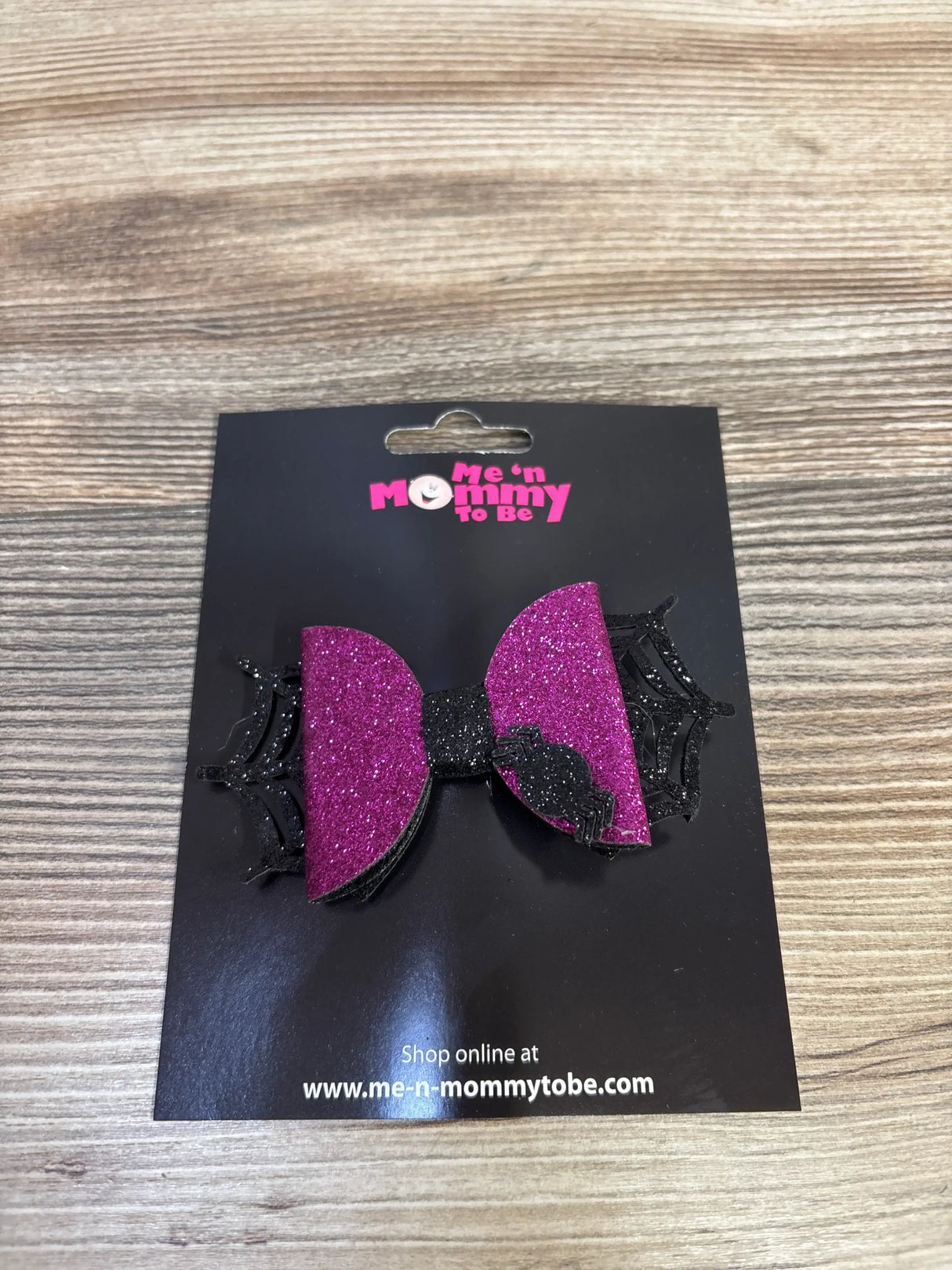 Pink glitter bow with black spiderweb and spider, kids Halloween hair accessory on display card