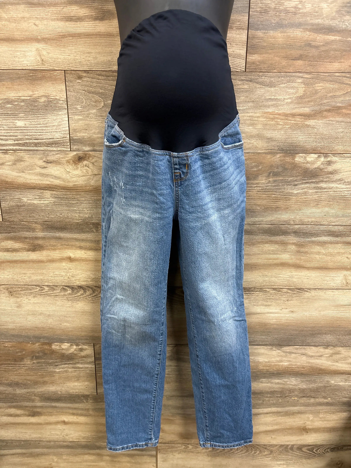 Front view of Isabel maternity 90s straight blue jeans with black belly panel and light wash on wood background