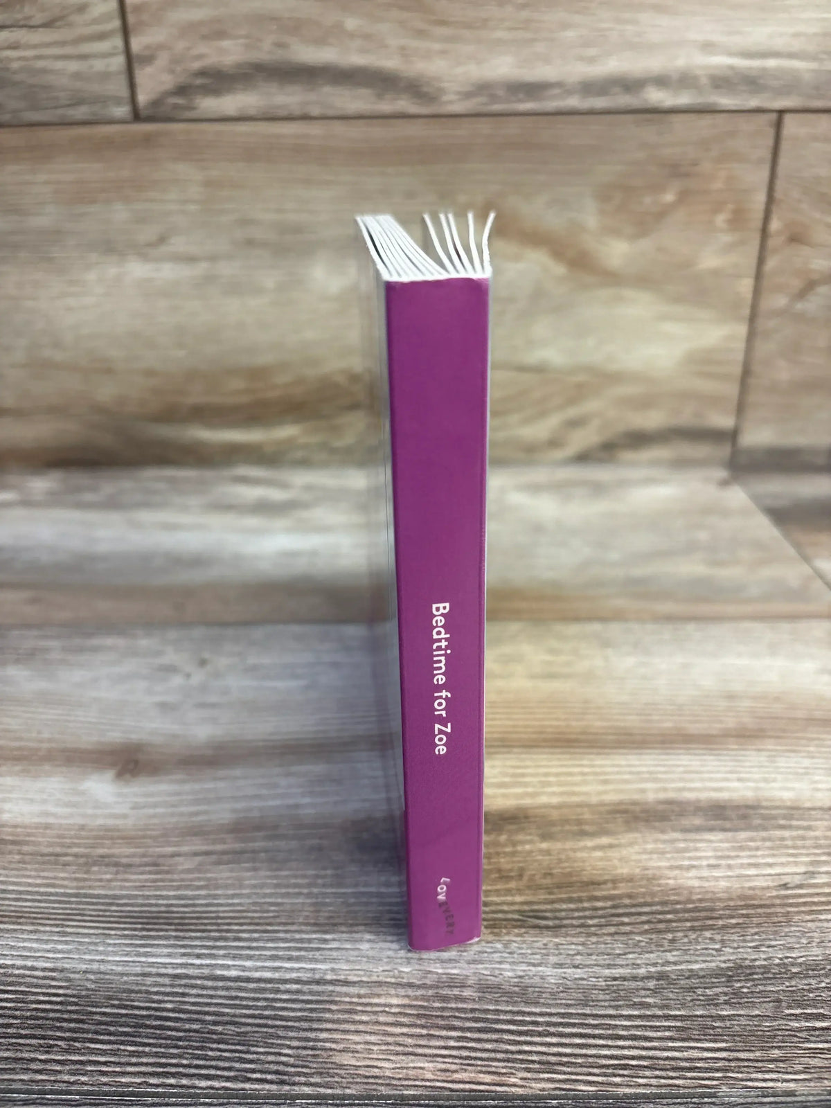 Purple 'Bedtime for Zoe' children's book on wood floor, kids bedtime story