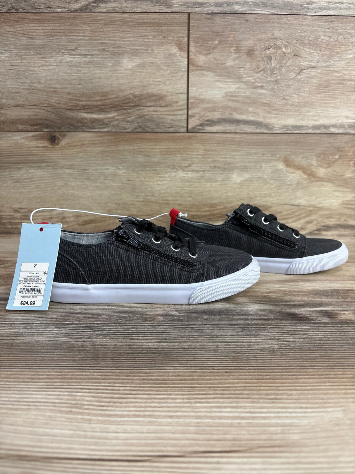 Side view of Cat and Jack Lucian double-zipper toddler sneakers in grey showing side zippers and white soles on wood floor