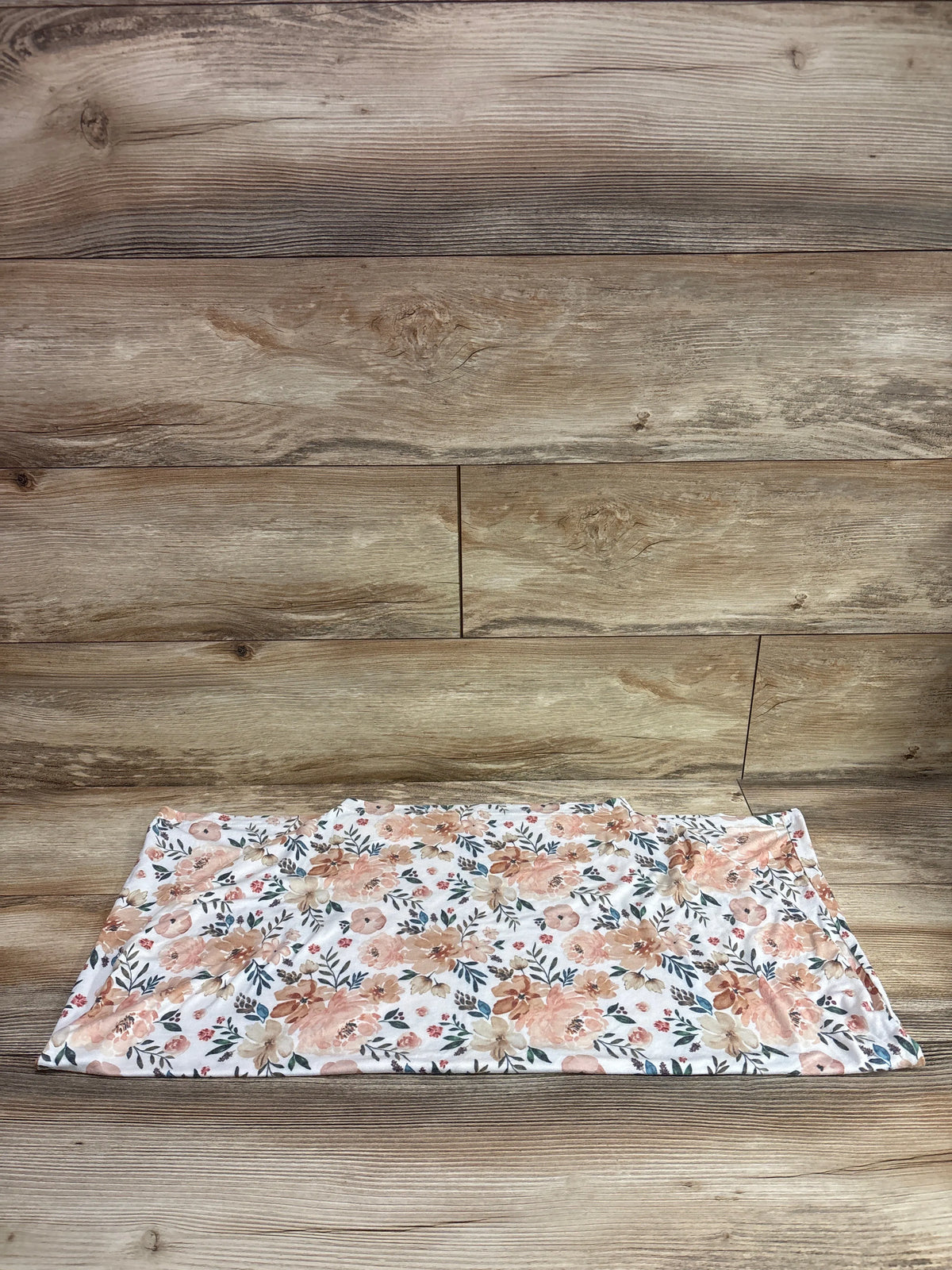 Copper Pearl stretchy 5-in-1 multi-use cover in white with a peach and blue floral print