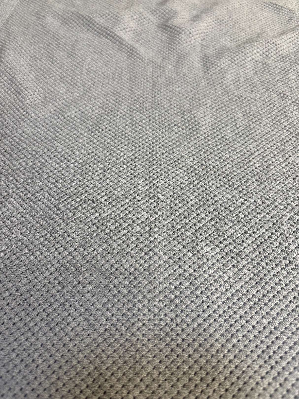 Close-up of soft gray waffle knit textured fabric for kids clothing or baby gear