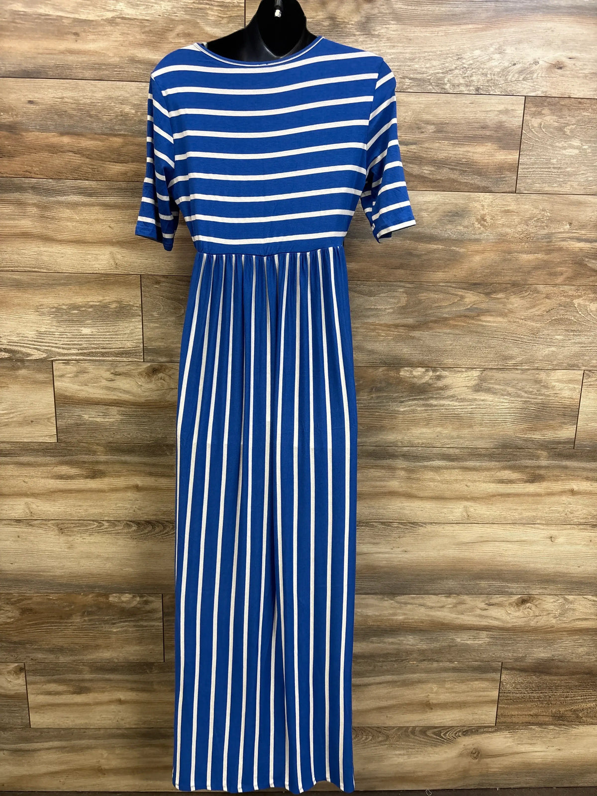 Front view of blue and white striped maternity maxi dress with short sleeves and empire waist on a black mannequin against wood background