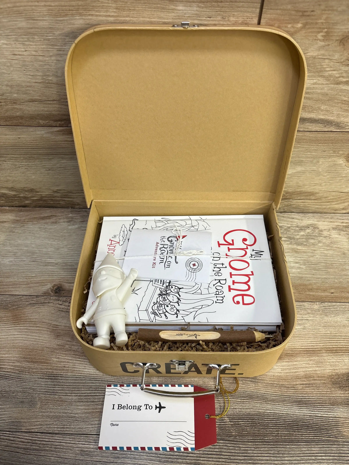 Open view of NEW My Gnome On The Roam Adventure Kit showcasing gnome, book, journal, and wooden pen in tan case