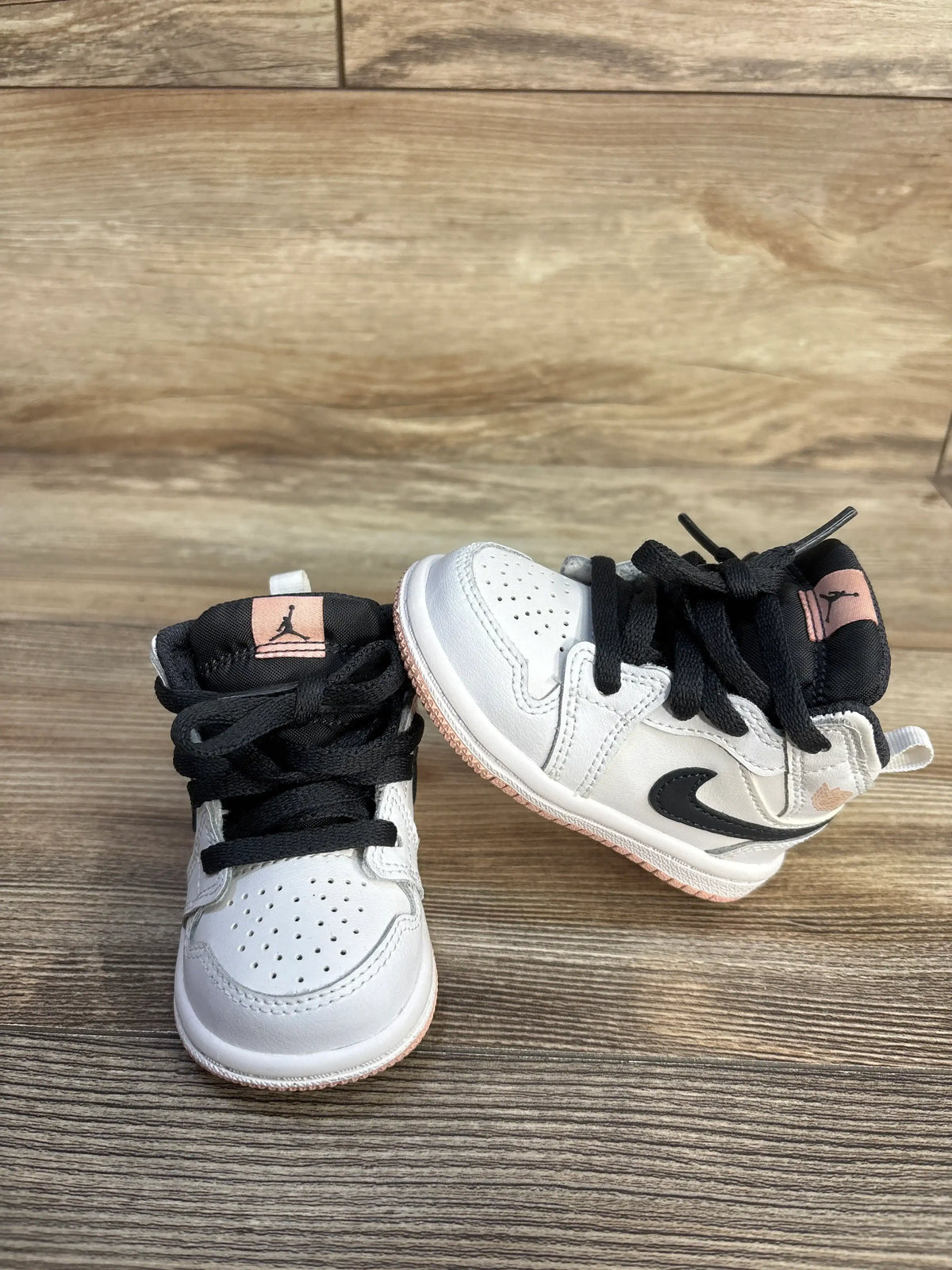 Air Jordan 1 Mid TD White Arctic Orange toddler sneakers on a wooden surface