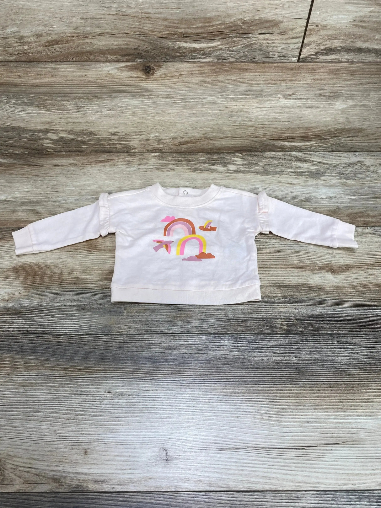 Front view of Cat & Jack newborn pink sweatshirt showcasing rainbow chest graphic with plain white background