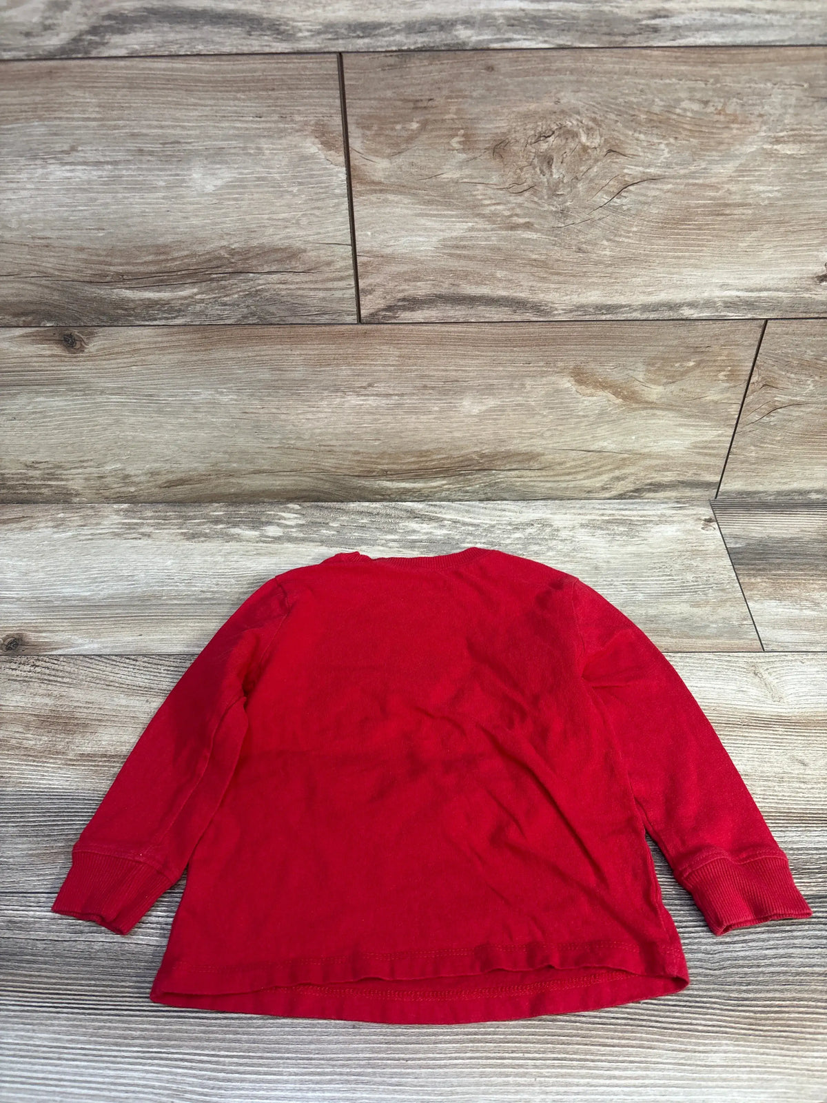 Red Old Navy long sleeve shirt for toddlers size 2T laid flat on a wooden background