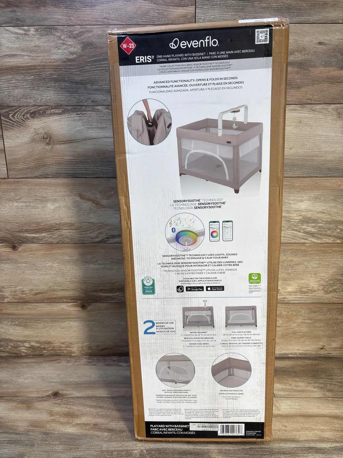 Front view of Evenflo Eris one-hand playard with bassinet in Coastal Coffee packaging showcasing two modes and SensorySoothe technology
