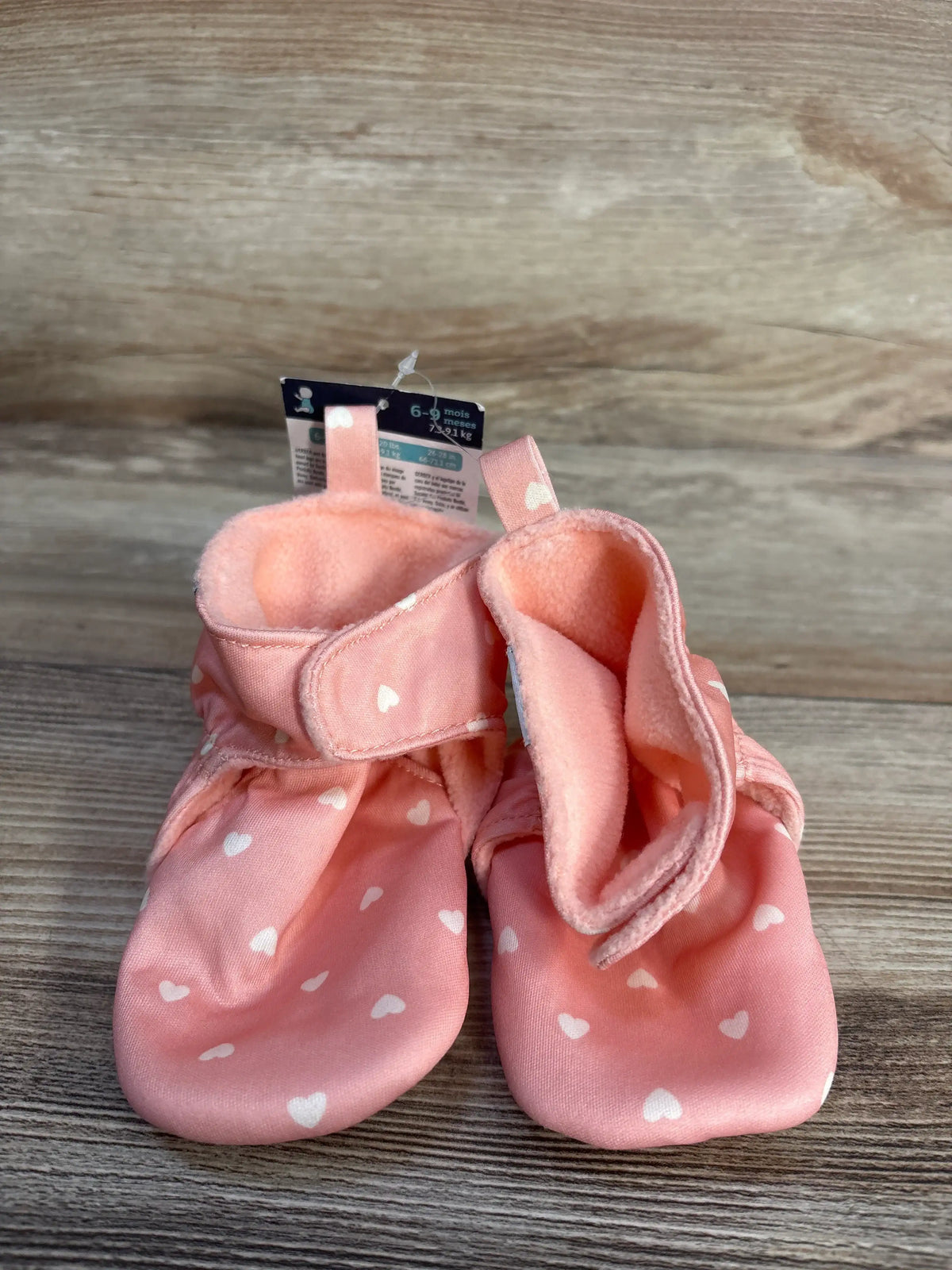 New pink soft baby booties with white heart print for size 6-9 months.