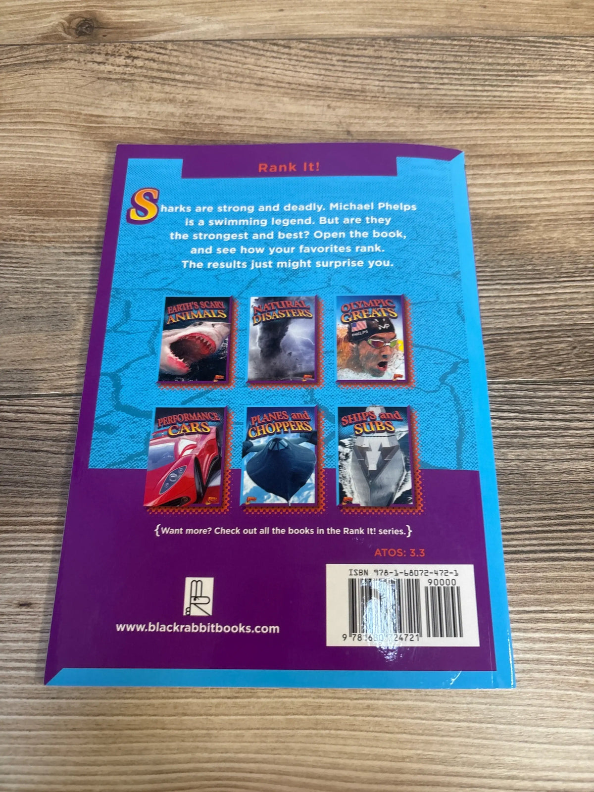 Back of Natural Disasters paperback showing Rank It headline, six series cover thumbnails and short summary on a wooden table