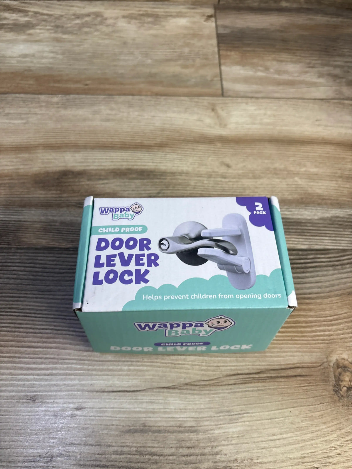 Top view of Wappa Baby Door Lever Lock 2-pack box showcasing child-proof lever lock illustration with wooden tabletop background