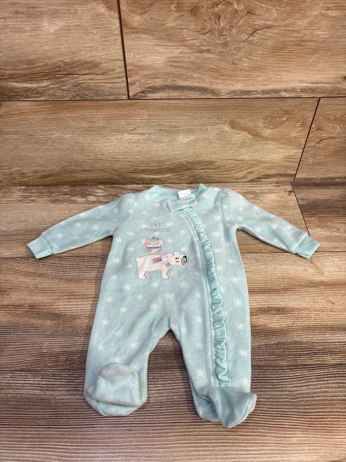 Front view of blue Koala Baby blanket sleeper for newborns showcasing star print, footed legs, and ruffled front on wood floor