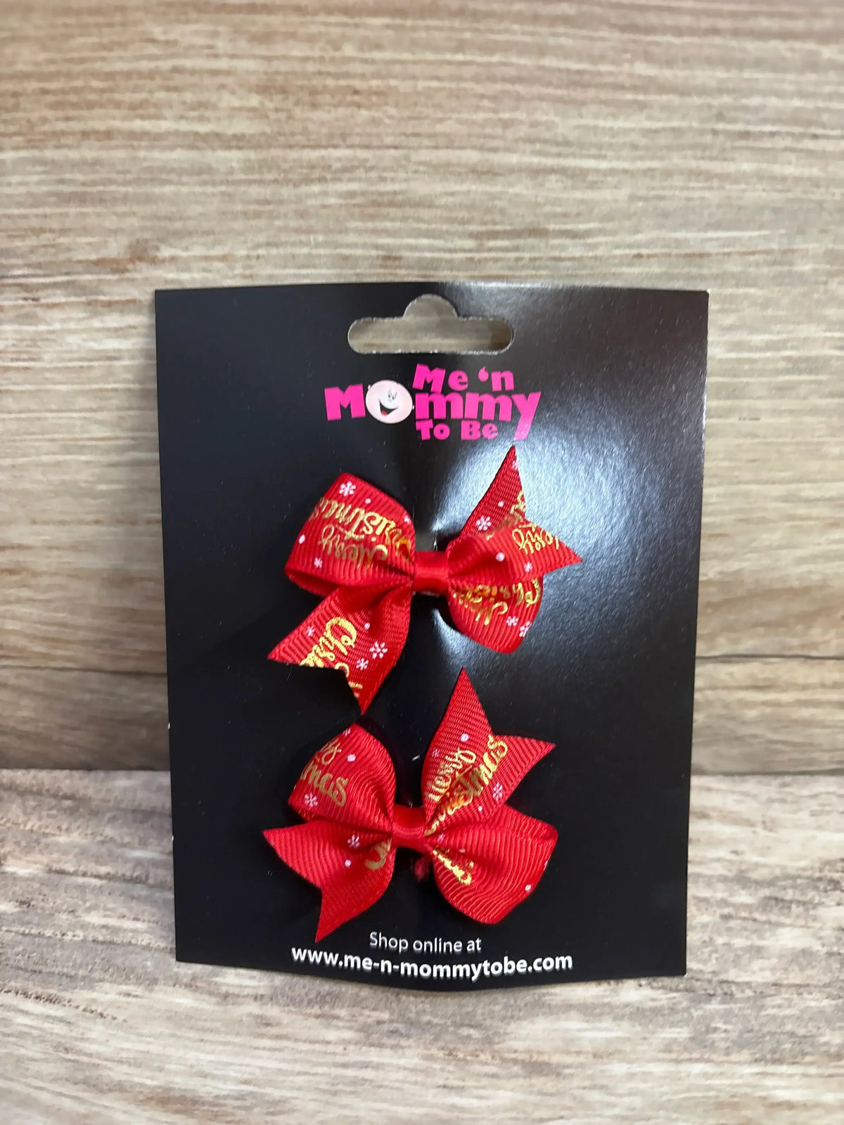 Red Christmas hair bows with gold 'Merry Christmas' text and snowflakes on black card