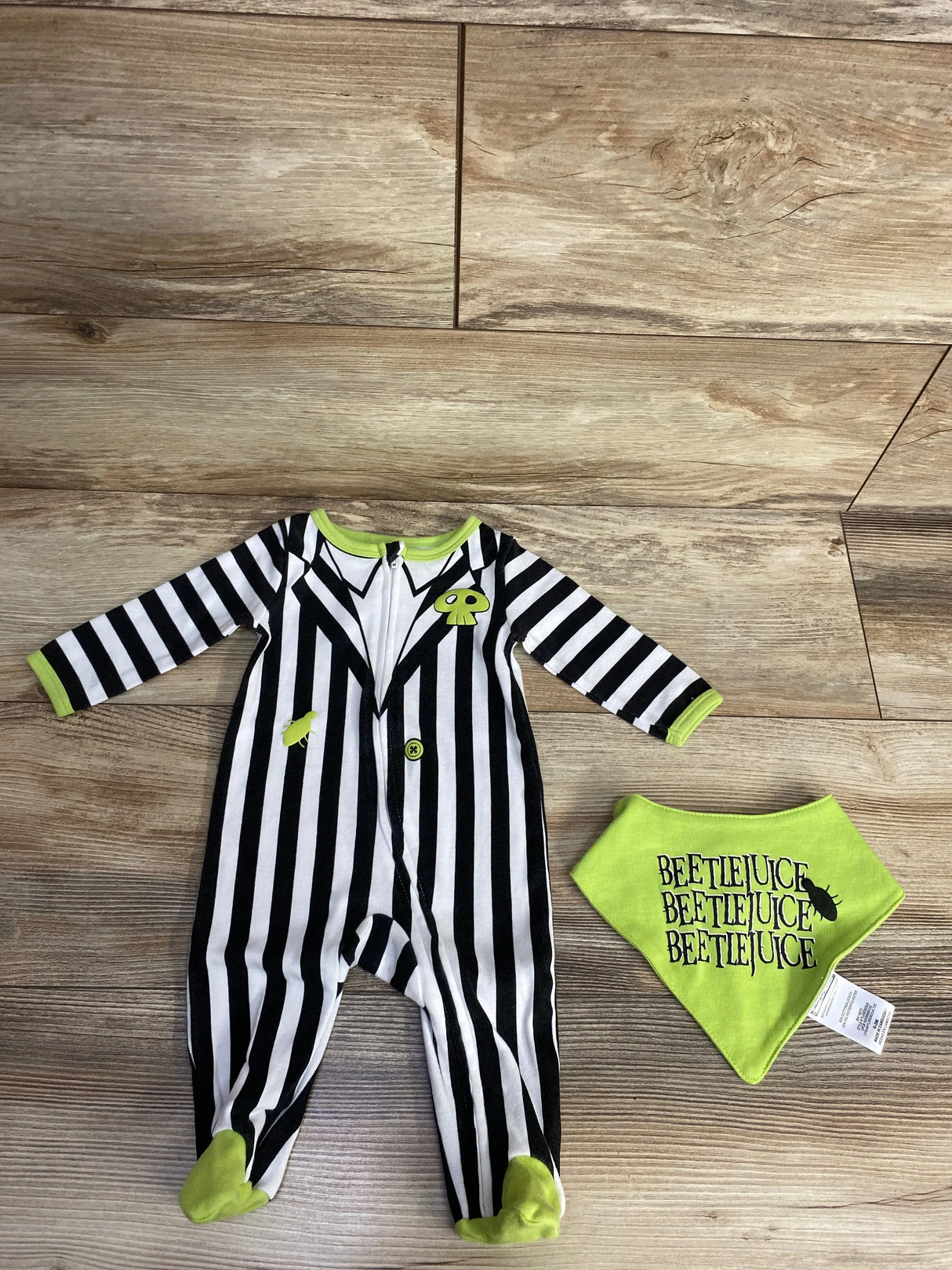 Beetlejuice-themed baby onesie with black and white stripes, green accents, and matching bib for Halloween.
