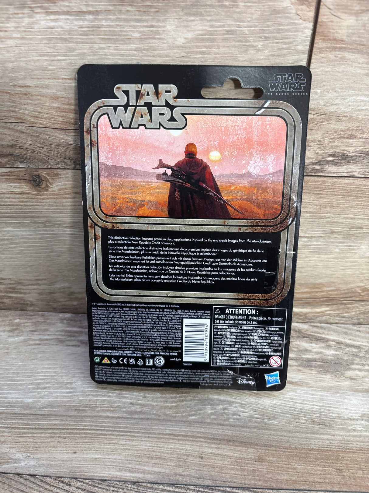 Back of Star Wars Boba Fett action figure card with sunset Mandalorian artwork and STAR WARS logo on wood