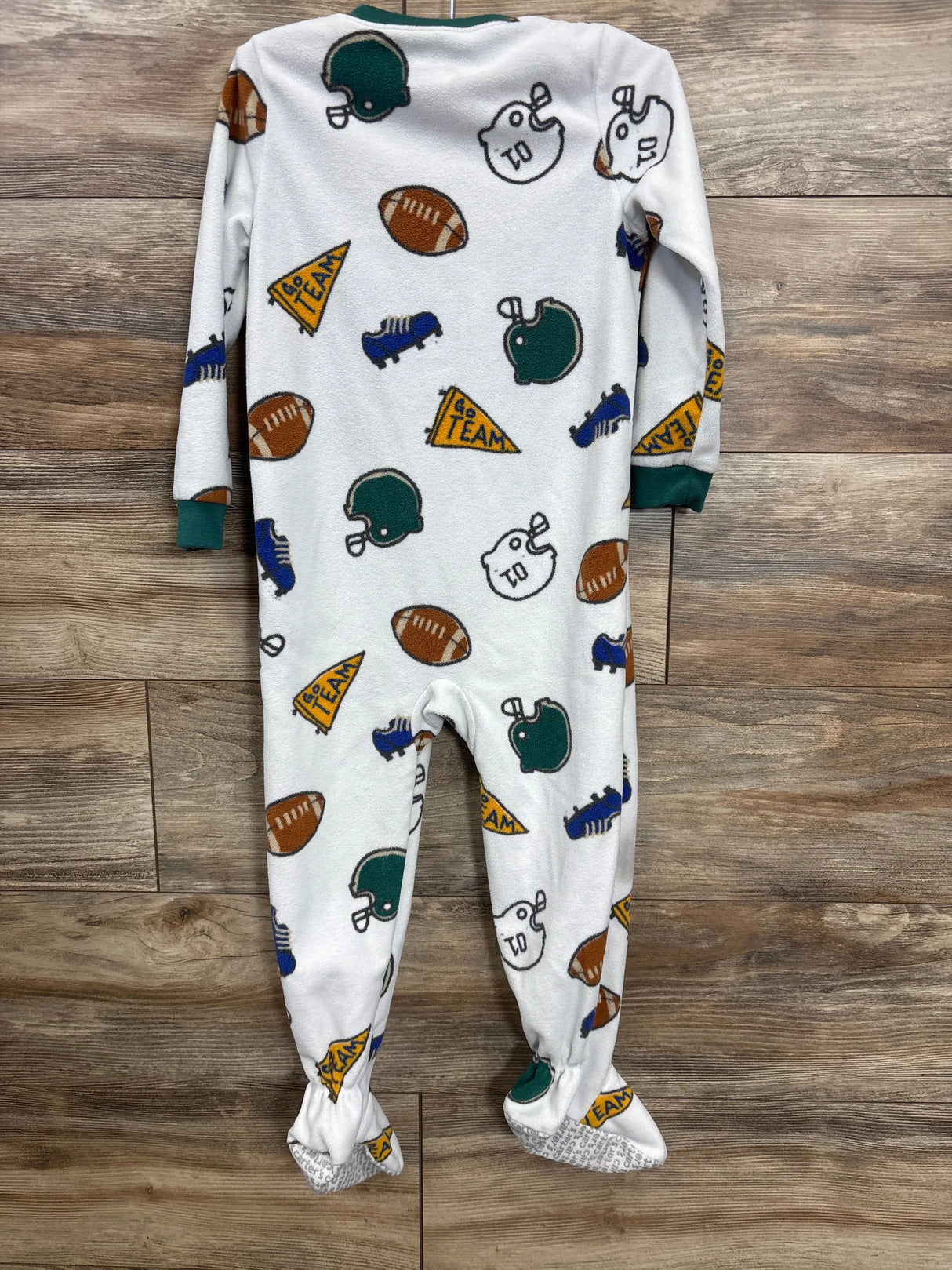 White baby footed pajamas with football helmets, balls, sneakers, and 'Go Team' pennants