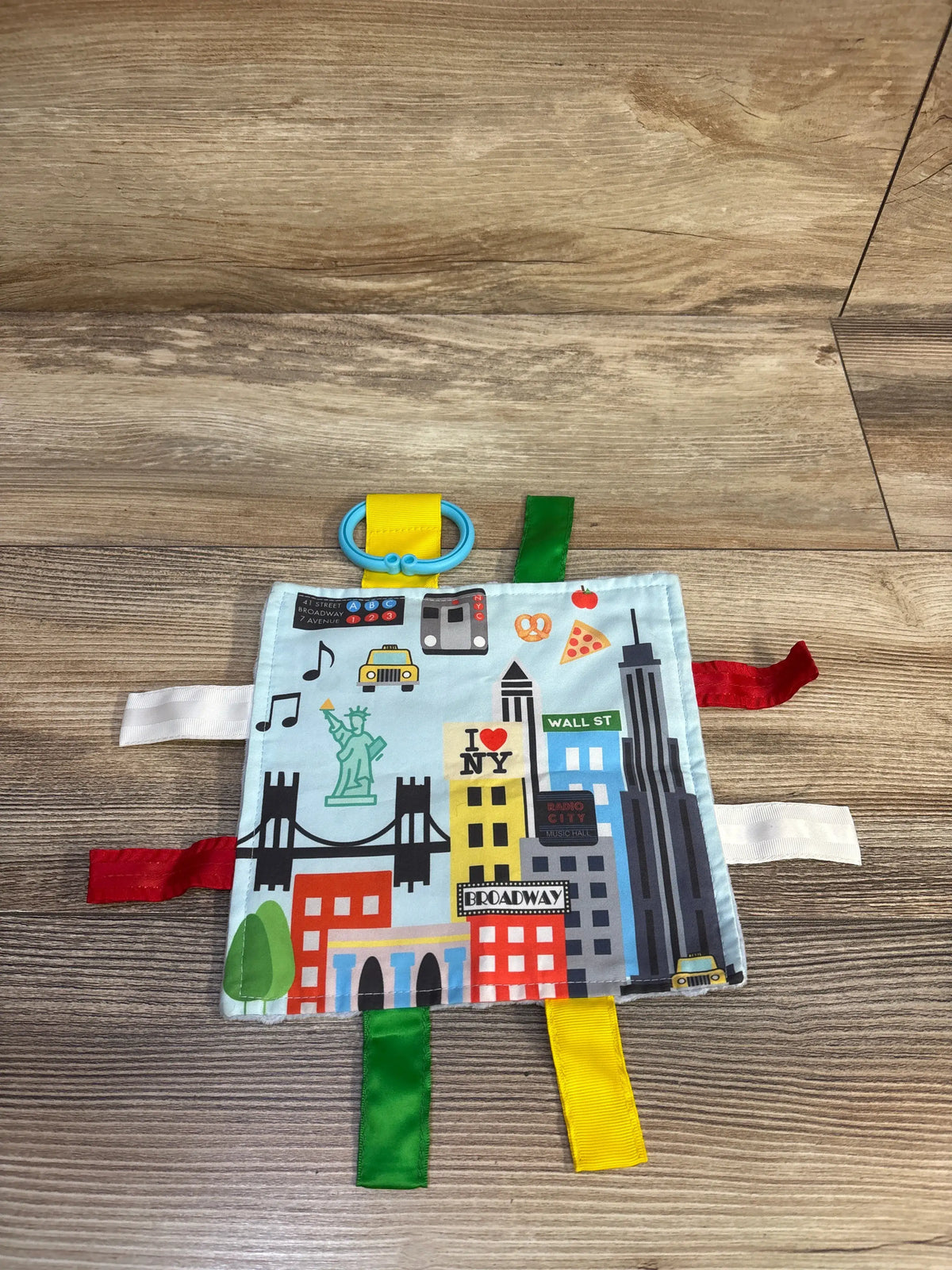 Jack & Co Learning Lovey NYC Tag Crinkle Sheet with colorful fabric tags and city graphics.