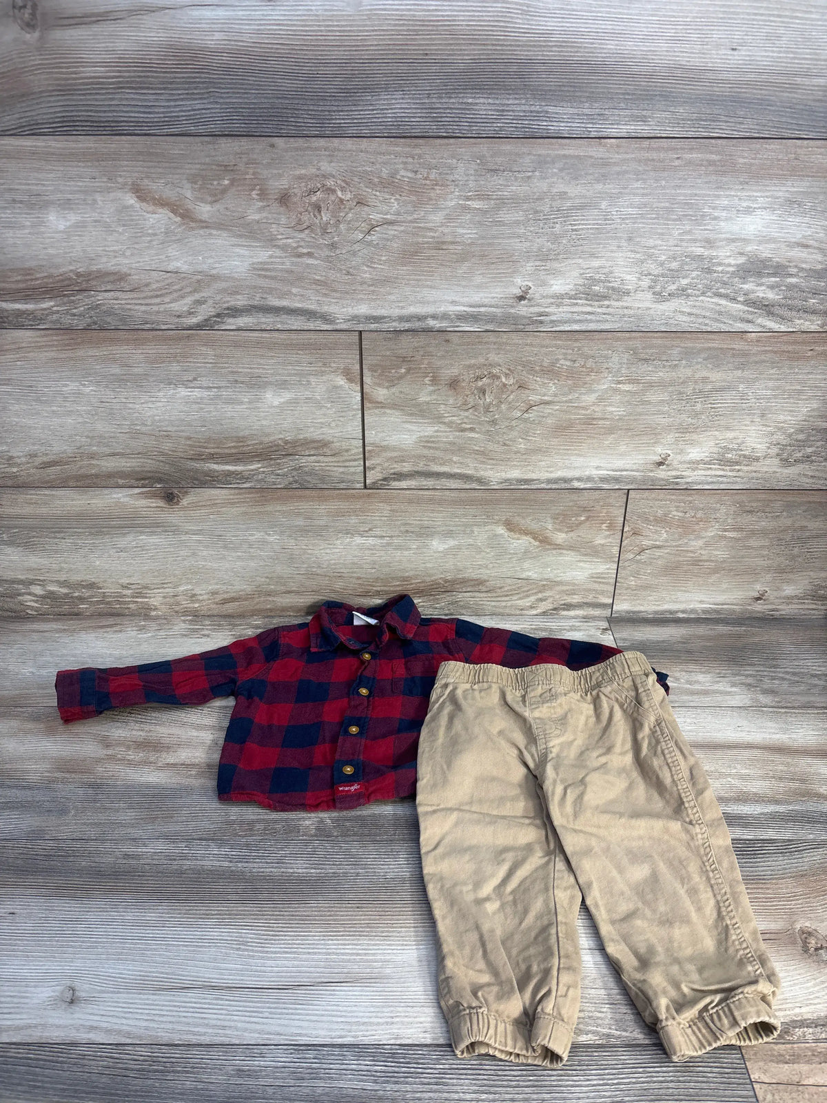 Wrangler 2pc Buffalo Plaid red shirt and khaki bottoms set for toddlers on a wood background