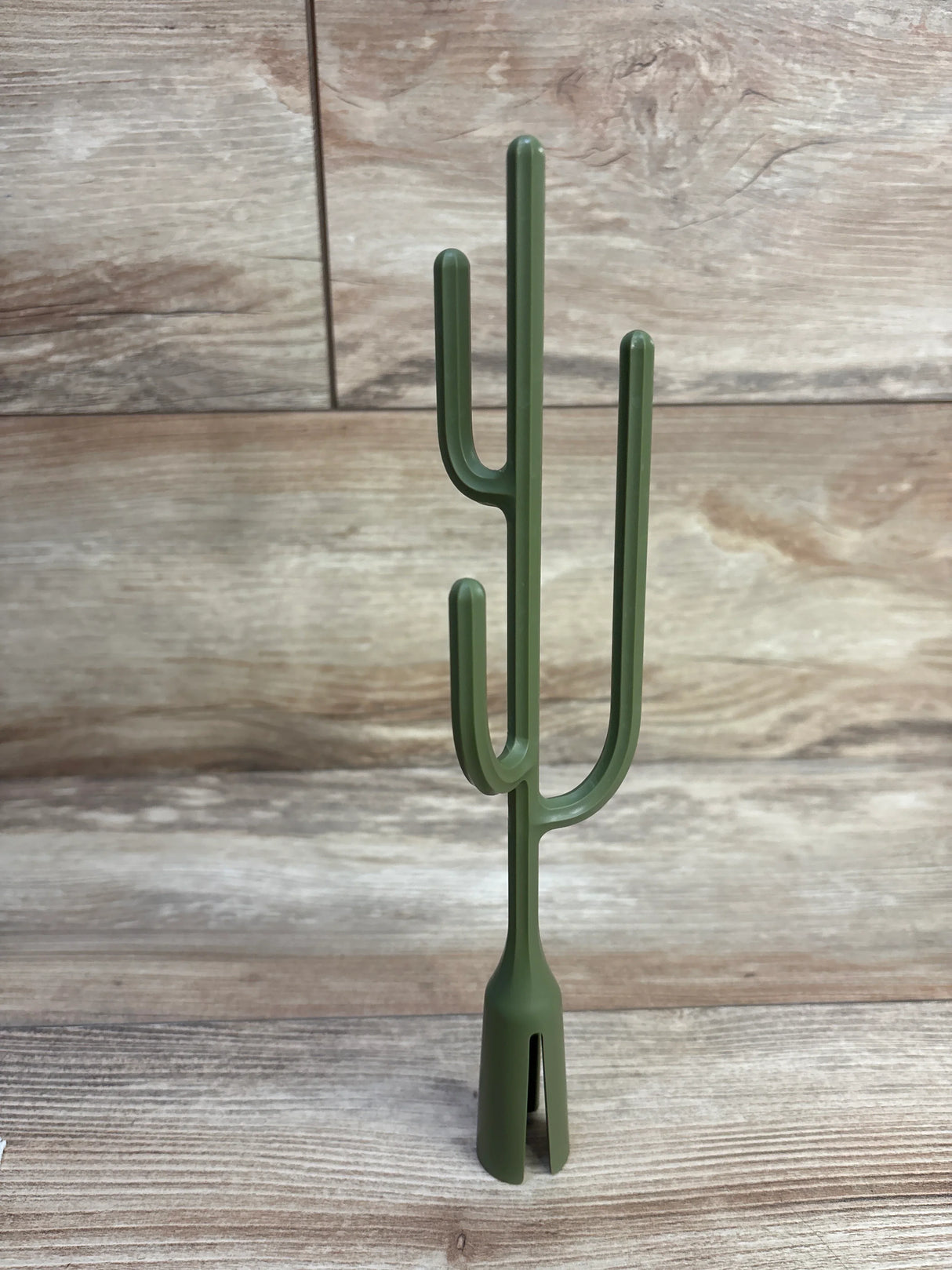 Front view of Boon Twig drying rack accessory (cactus) showcasing three curved drying arms and split base on wood plank background