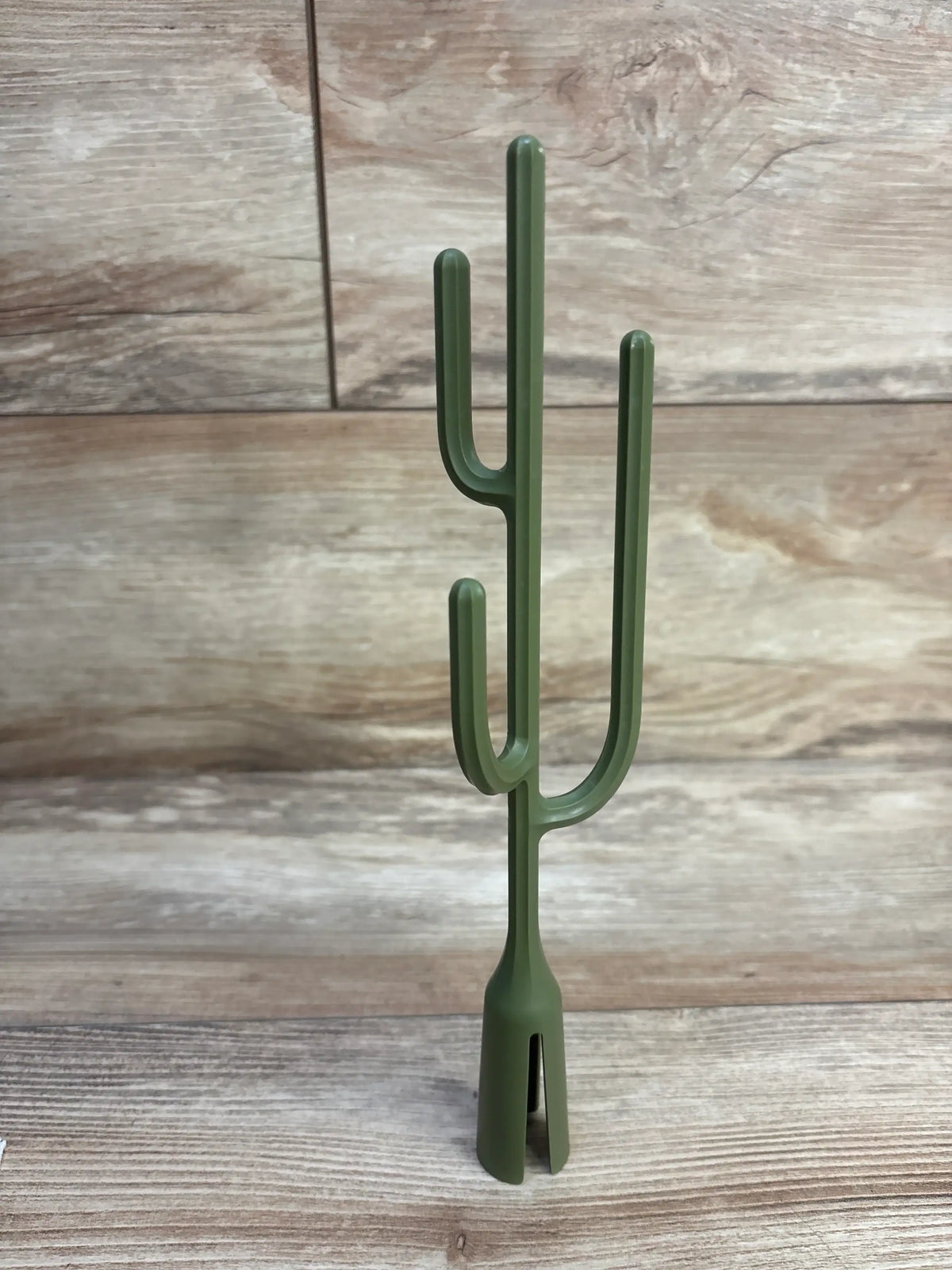 Front view of Boon Twig drying rack accessory (cactus) showcasing three curved drying arms and split base on wood plank background