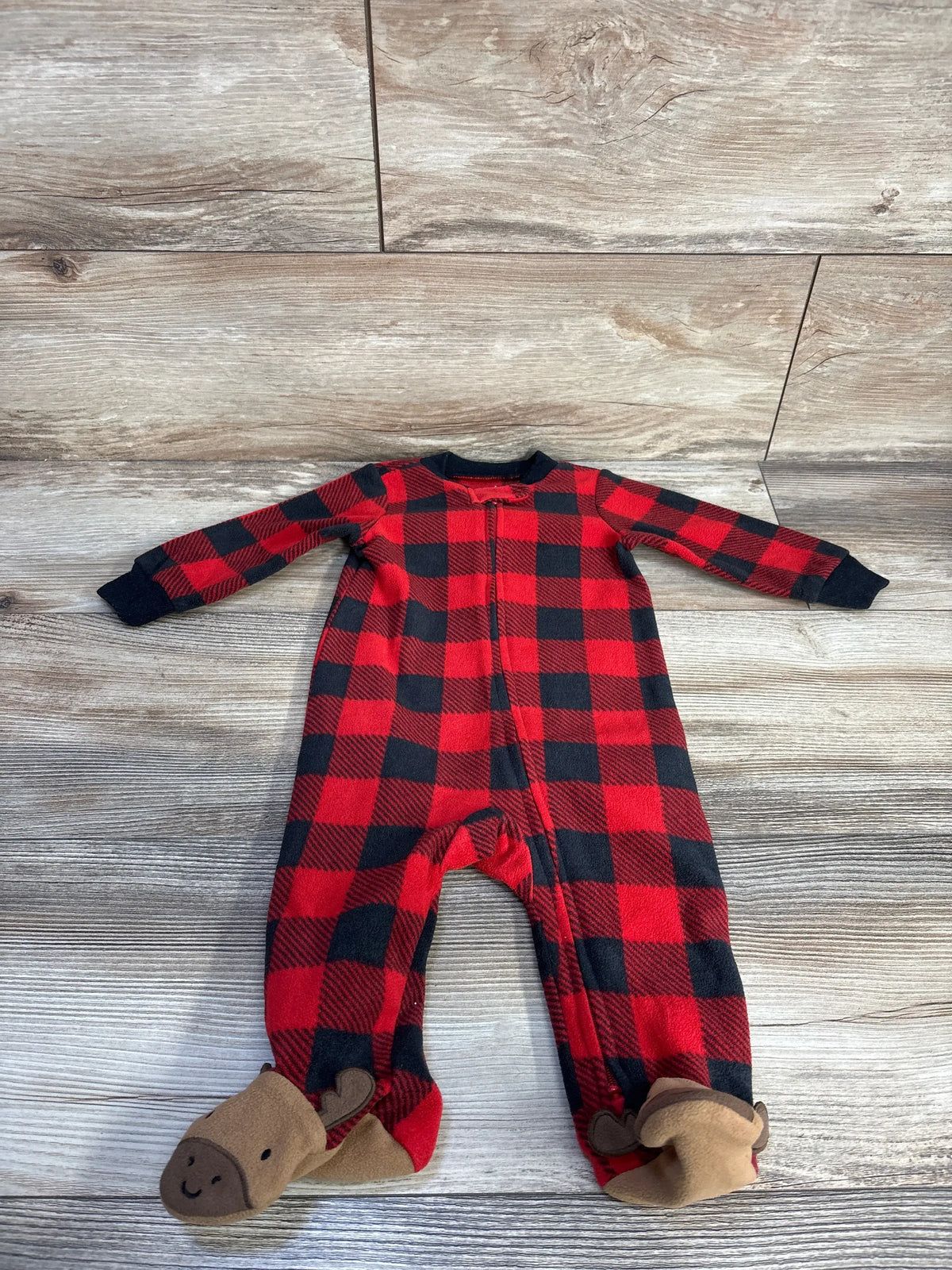 Front view of Carter’s red and black plaid blanket sleeper showcasing long sleeves, front zipper, and animal-face foot covers on wood flooring