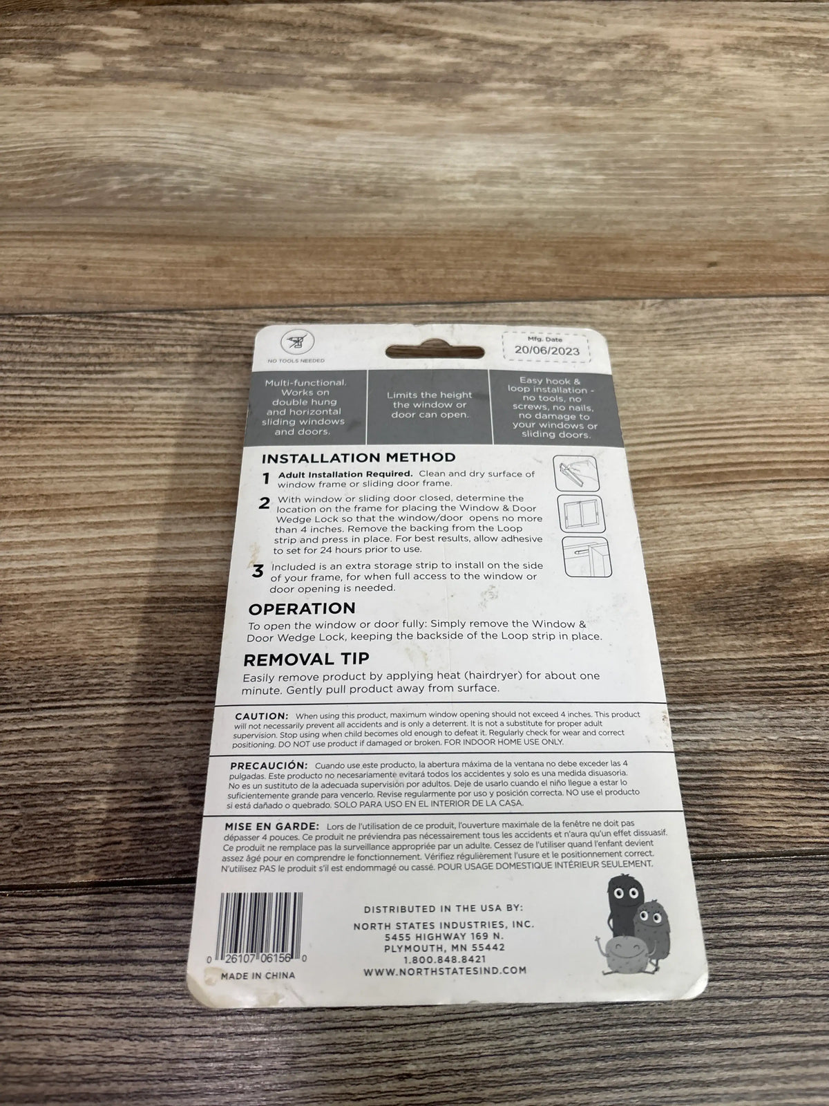 Back view of ToddleRoo Window & Door Wedge Locks 4pk packaging showing installation instructions on a wood surface