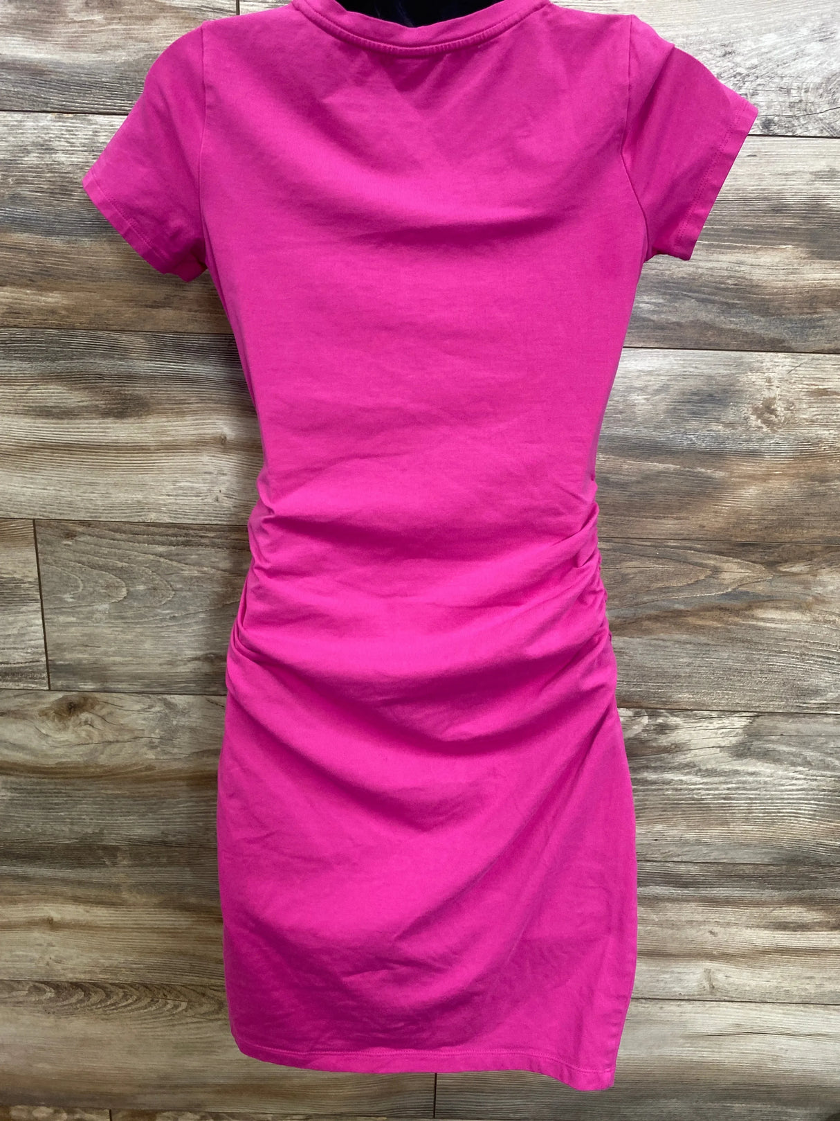 Bright pink maternity t-shirt dress with ruched side detail, perfect for pregnancy fashion and comfort.