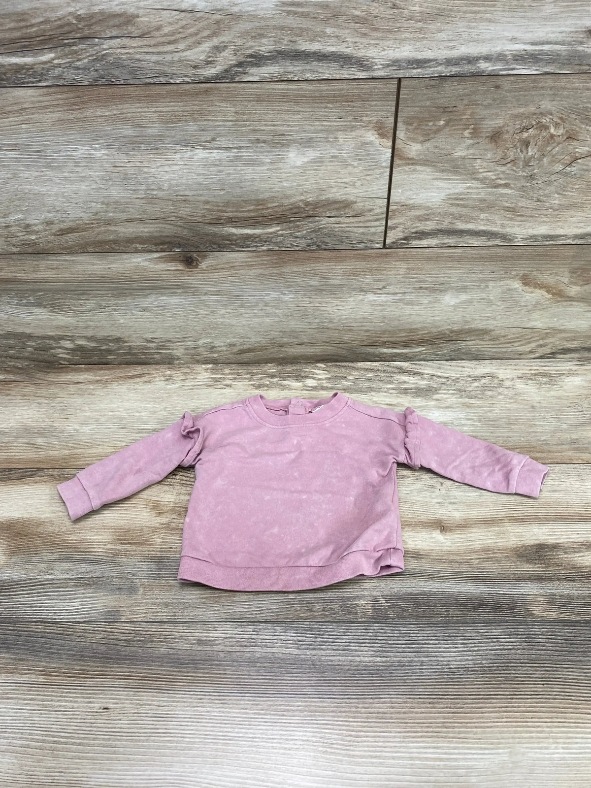 Front view of Cat & Jack pink baby sweatshirt size 0-3M showing crewneck, long sleeves, and ribbed cuffs on white background
