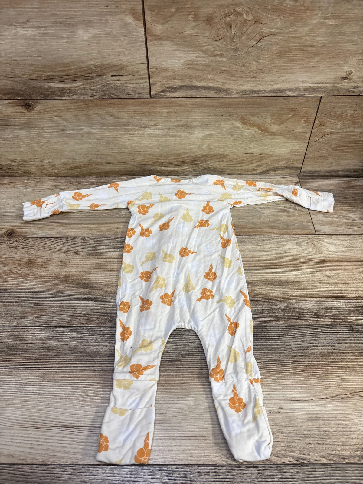 Flat-lay of Georgie’s Corner white bamboo convertible sleeper, size 3 to 6 months, with floral print and fold-over cuffs