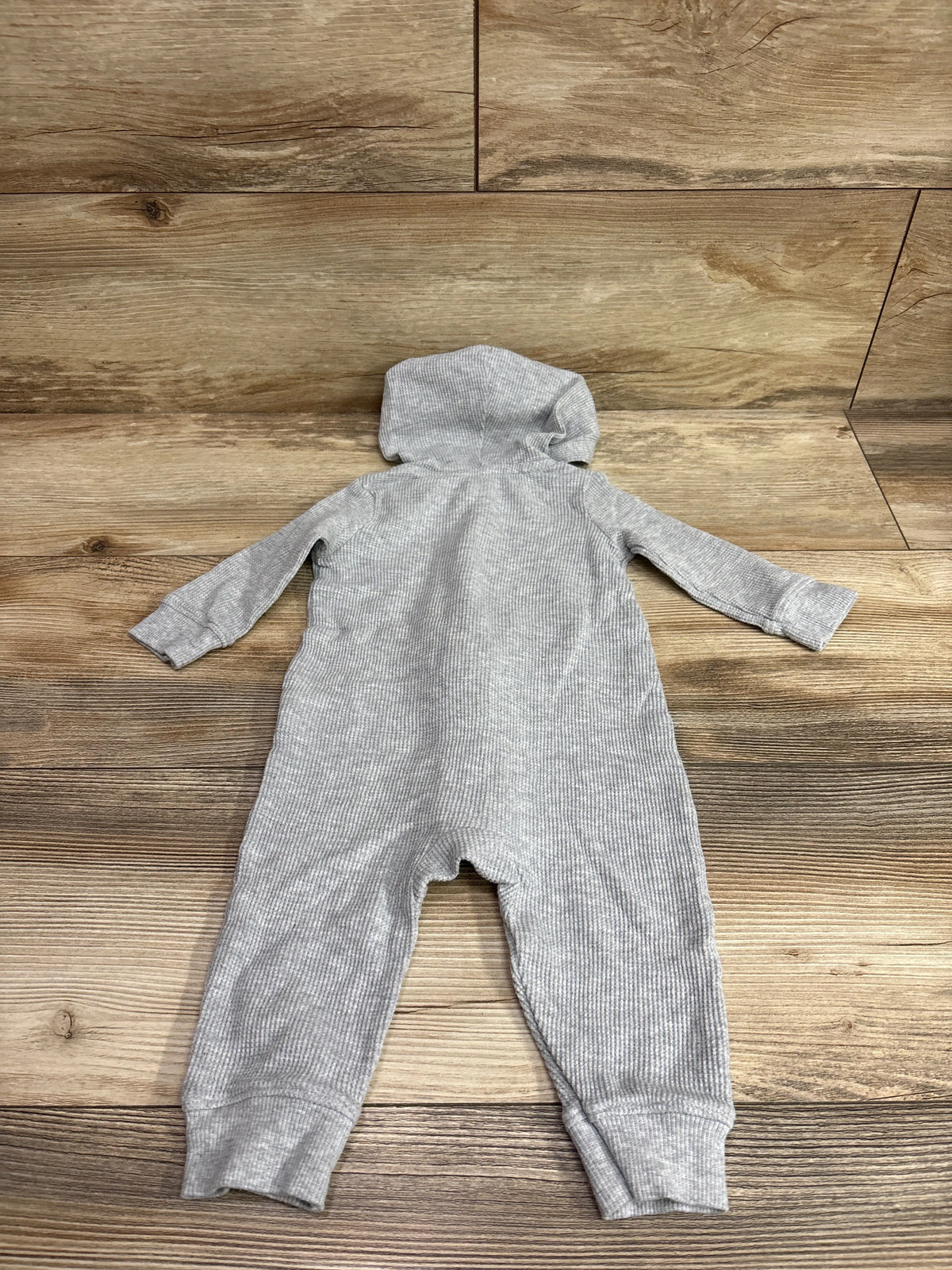 Back view of Carter’s grey waffle knit hooded coverall showcasing long sleeves and ribbed cuffs on a wood floor